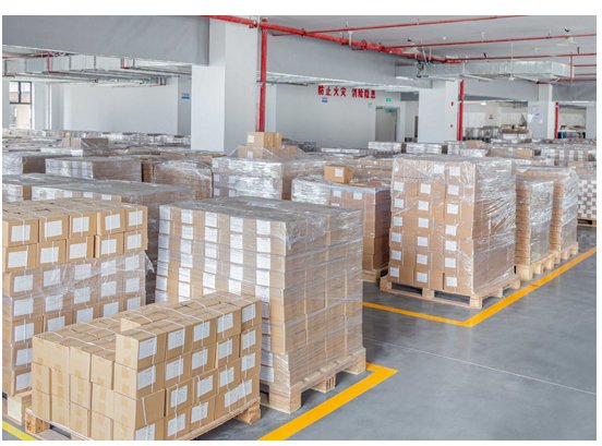 Finished packaging cartons shrink-wrapped on pallets in the VARELTON despatch warehouse