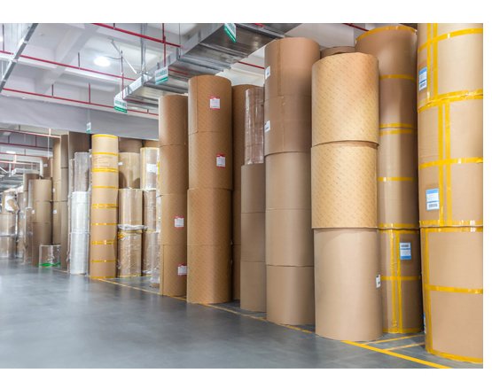 Kraft paper reels stored upright for paper-faced bubble mailer production