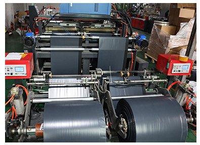 Bag-making machine running printed poly film into finished courier mailers at the VARELTON plant